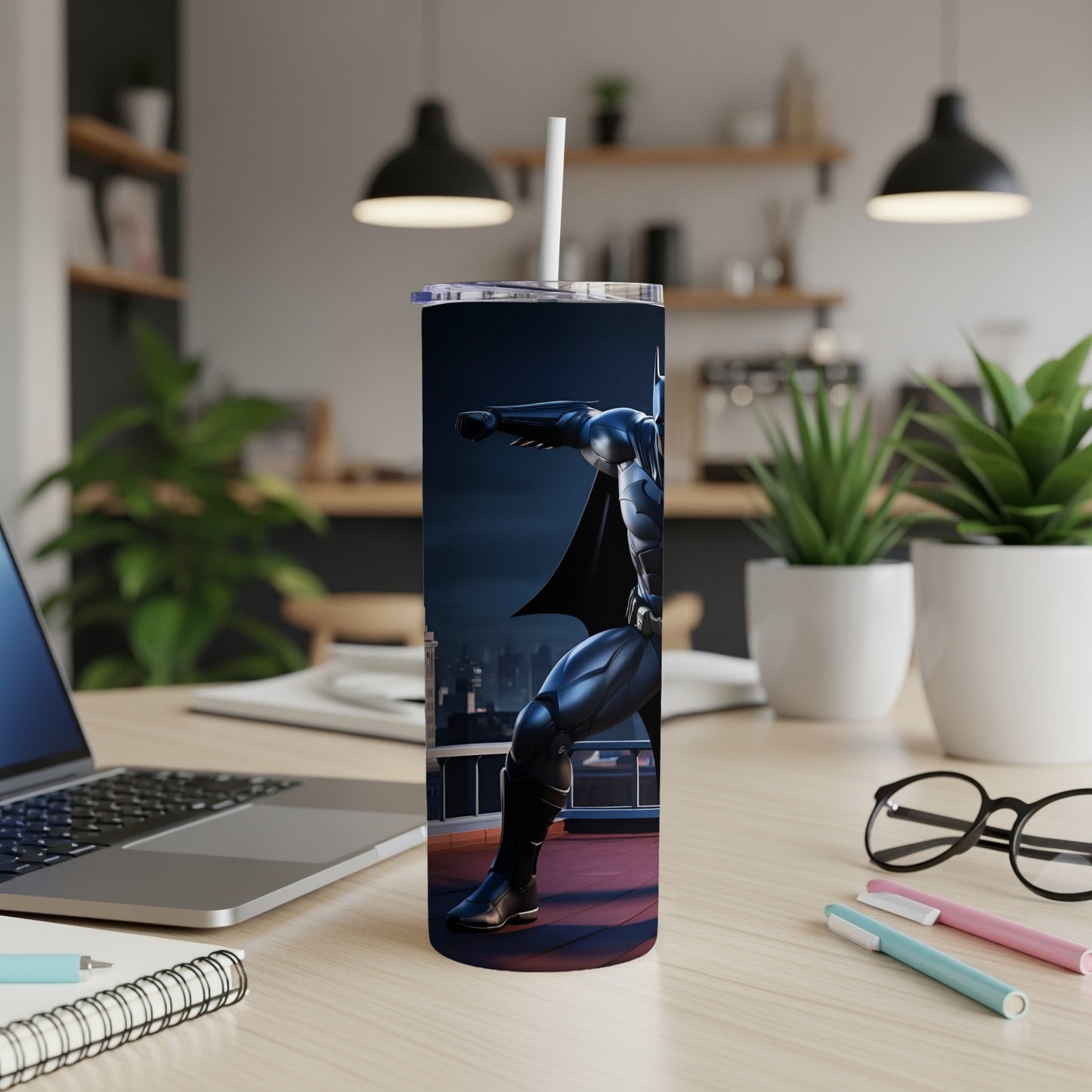 Batman superhero design on a tumbler with a straw, on a desk.