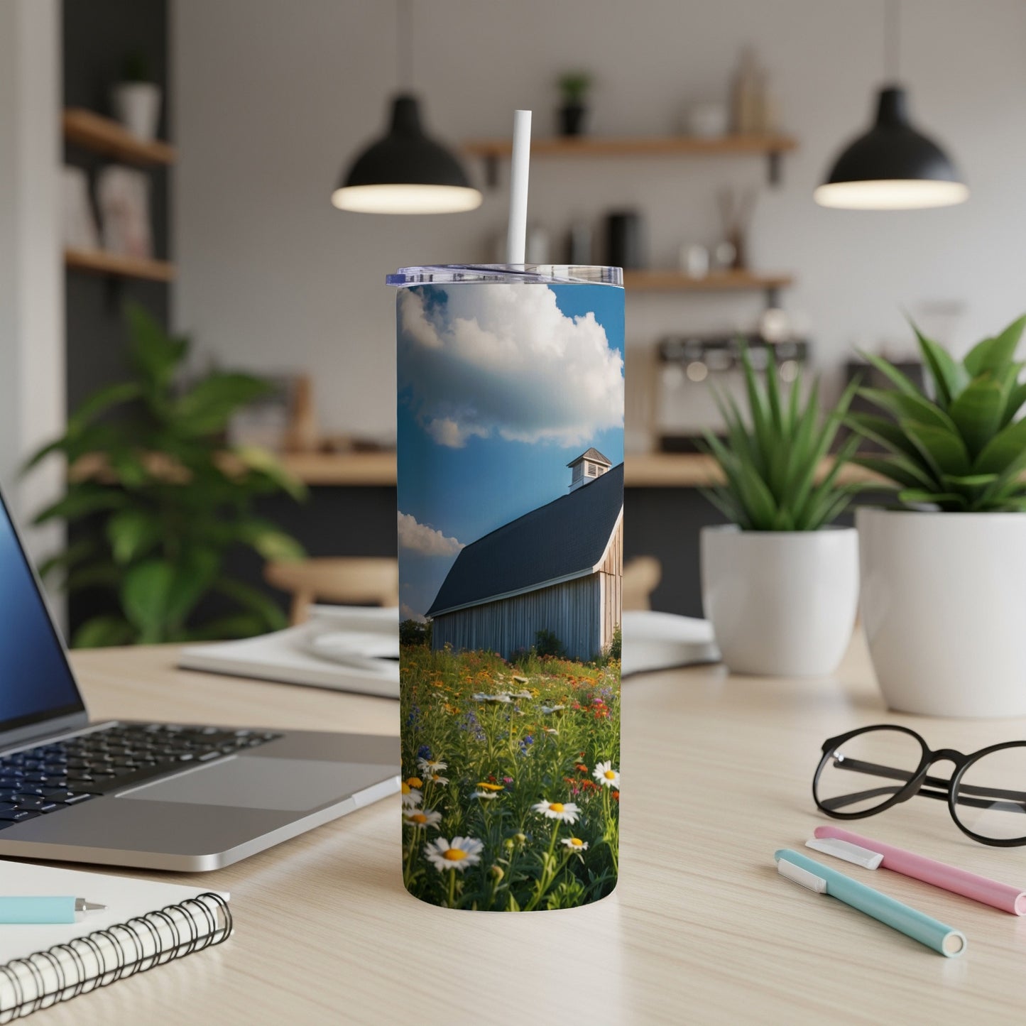 Tumbler with rustic barn and wildflowers in a field.