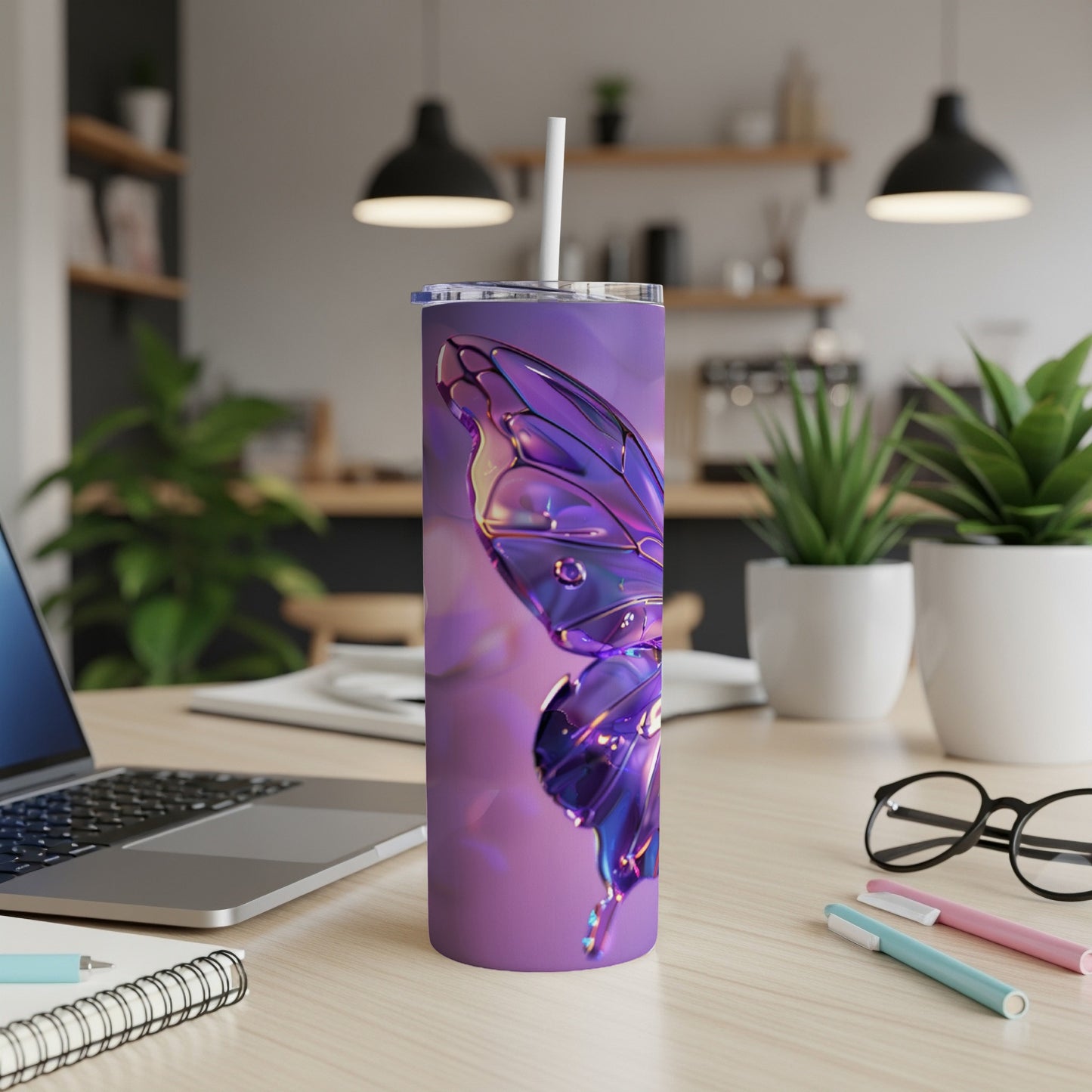 Purple iridescent butterfly tumbler with straw on desk.