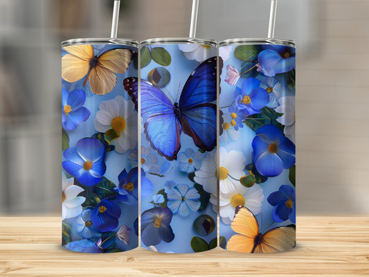 Blue tumbler with butterflies and white and blue flowers.