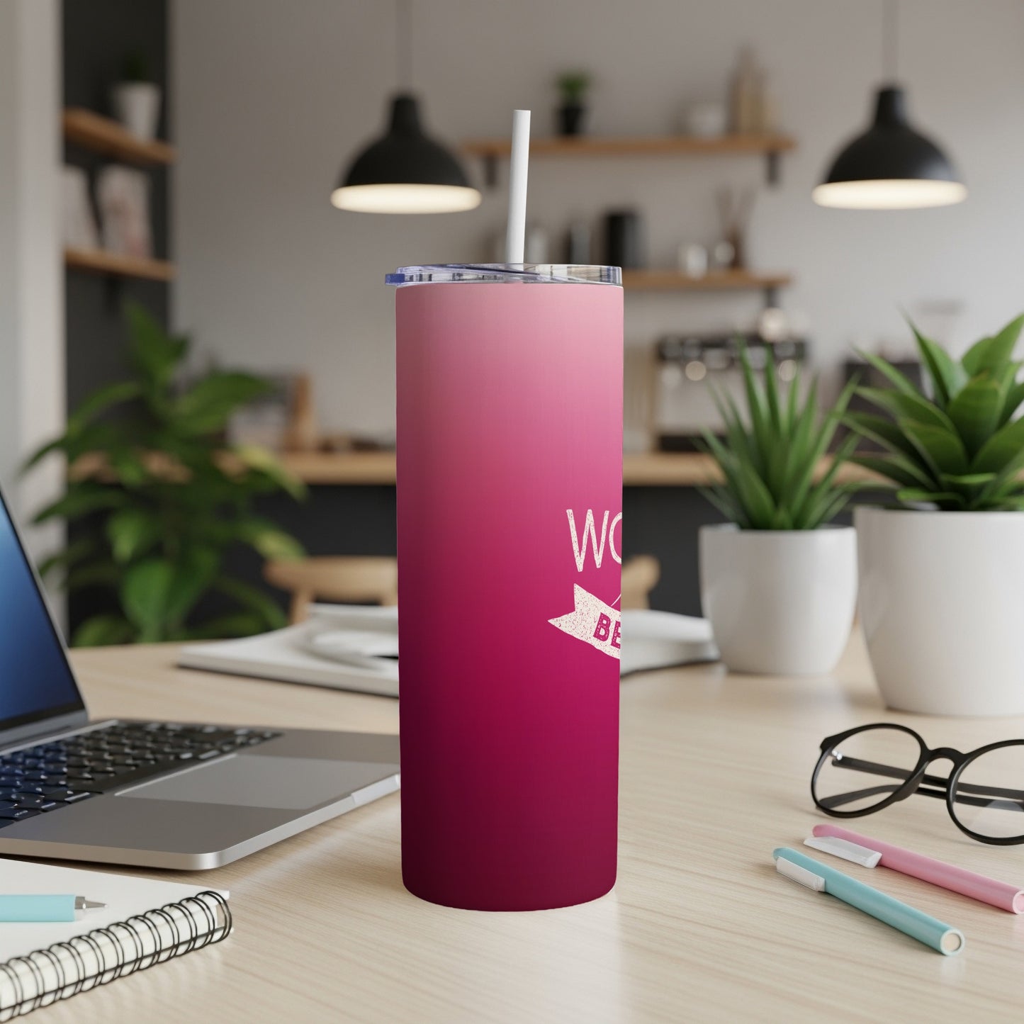 Pink gradient tumbler with "World's Best" text on a desk.