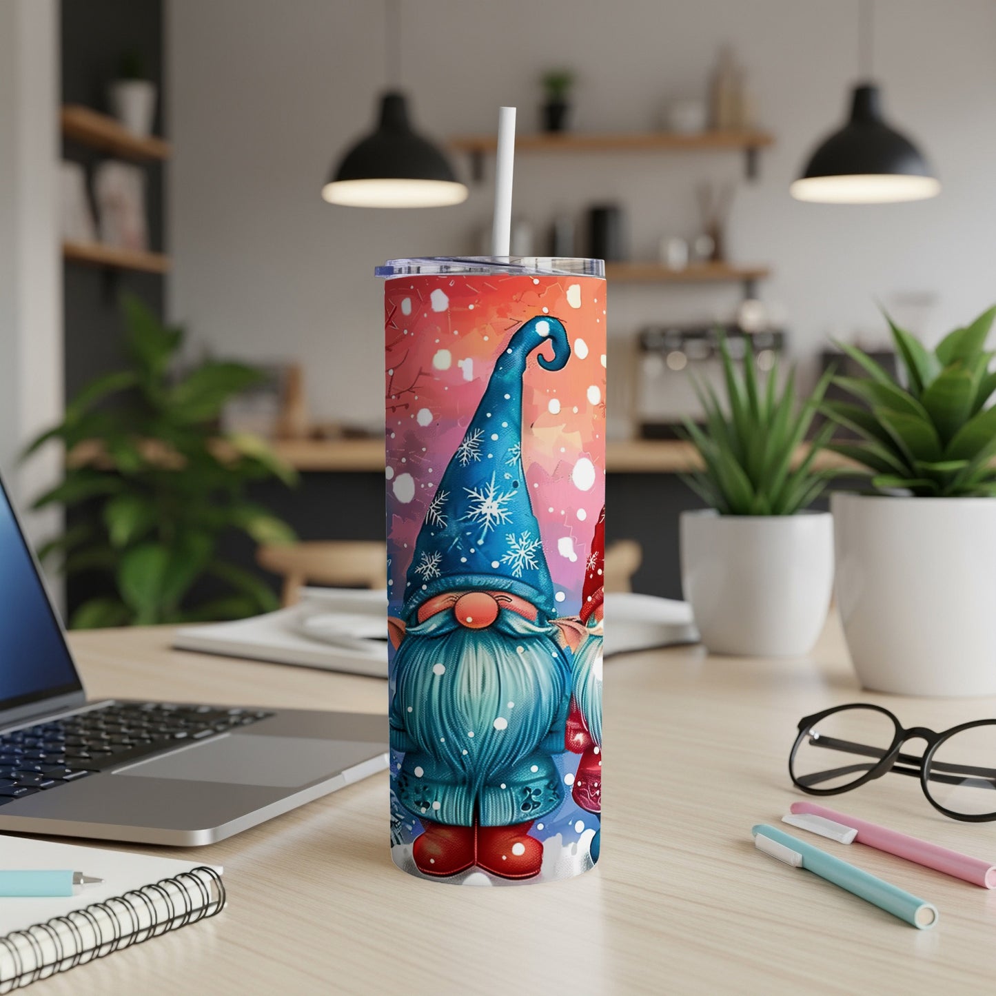 Two gnomes with Santa hats stand on a snowy background on a tumbler.