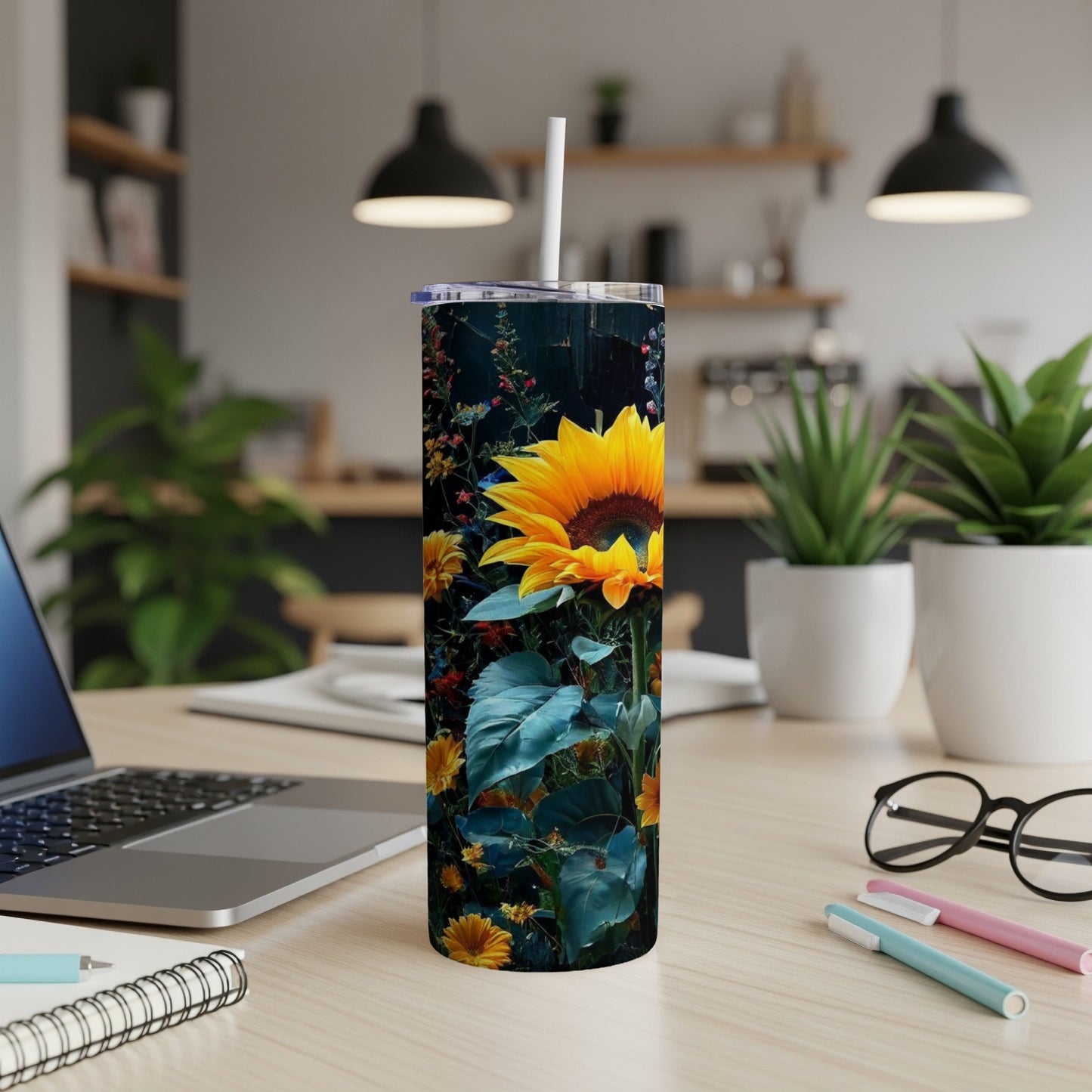 Tall tumbler with a vibrant sunflower and foliage design on a desk.