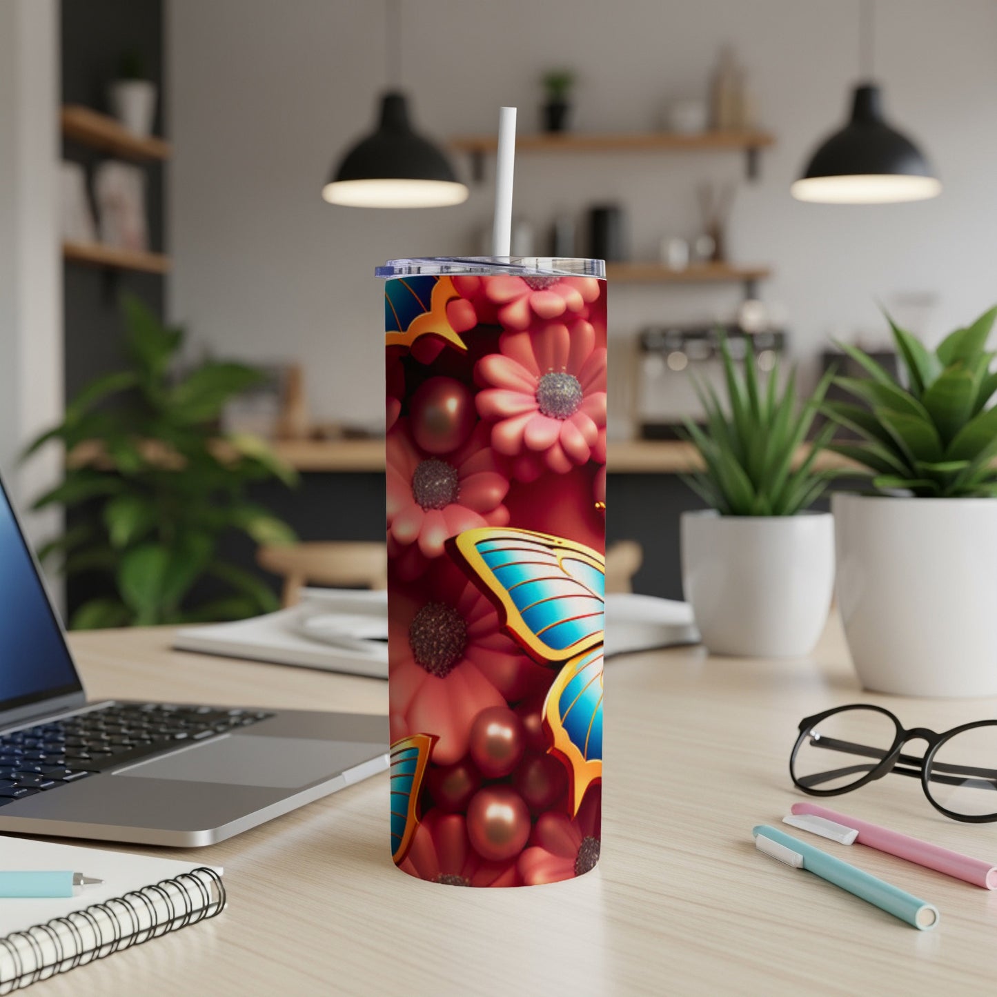 Tumbler with colorful floral pattern and large blue butterfly.