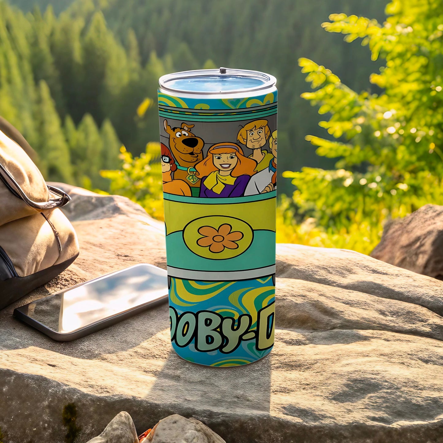 Scooby-Doo characters and logo wrap around a blue and green patterned tumbler.