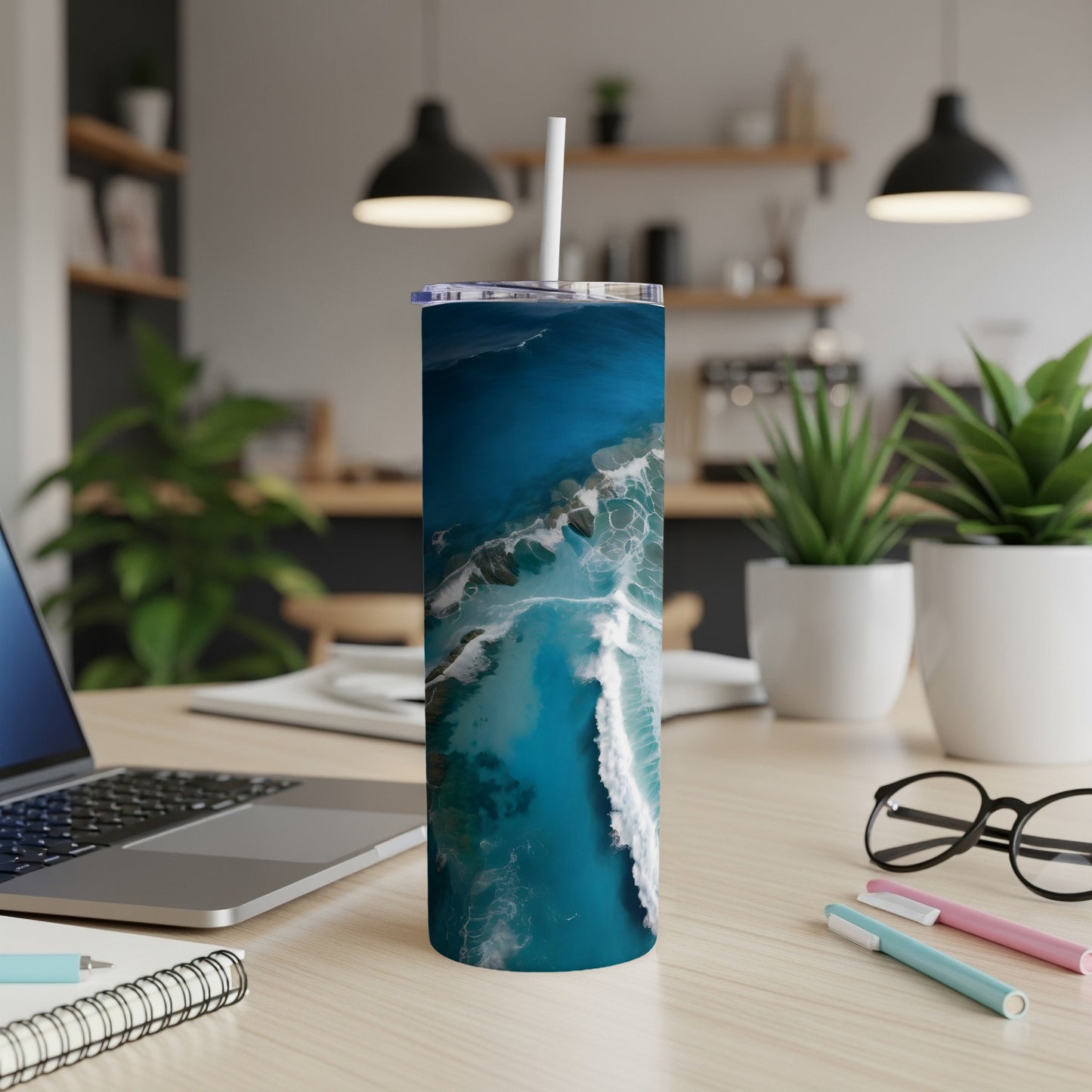 Ocean wave design on a white tumbler with straw.