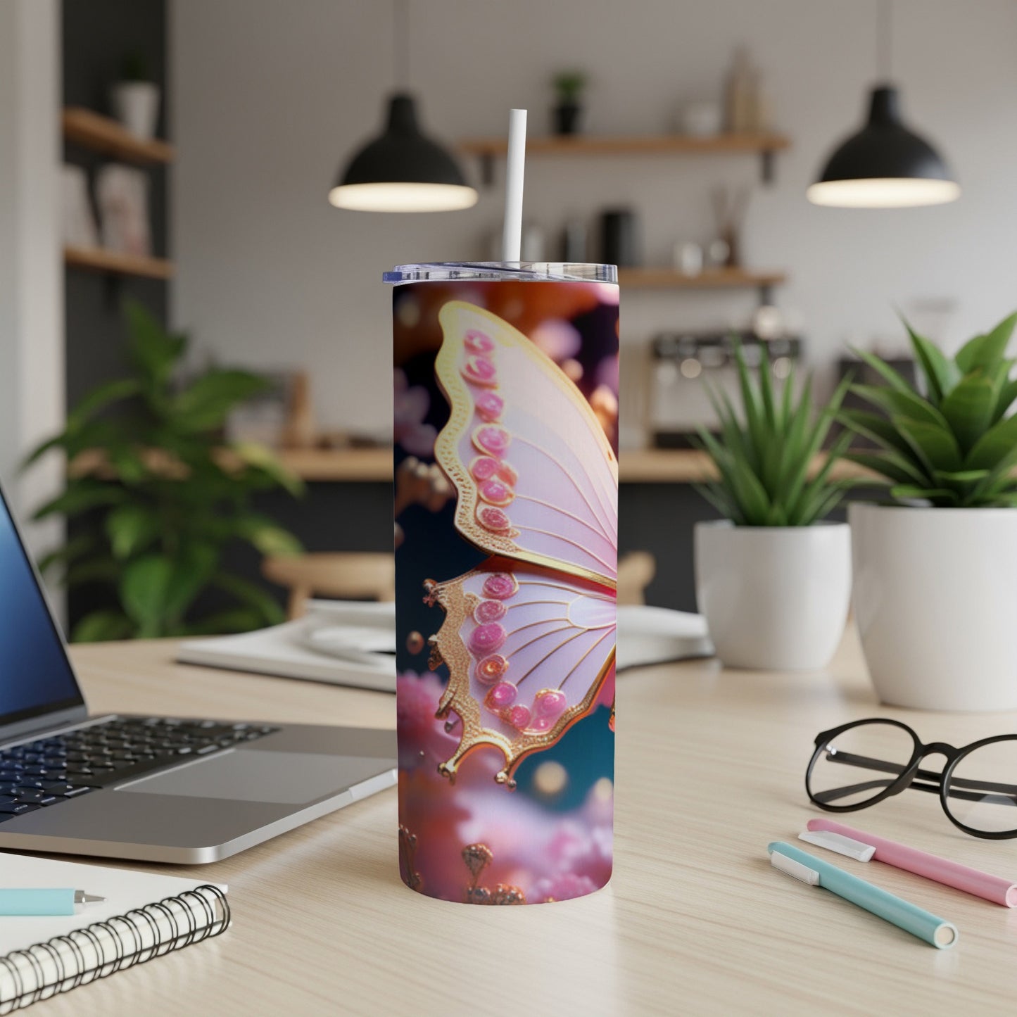 White butterfly wing tumbler with pink floral accents on desk.