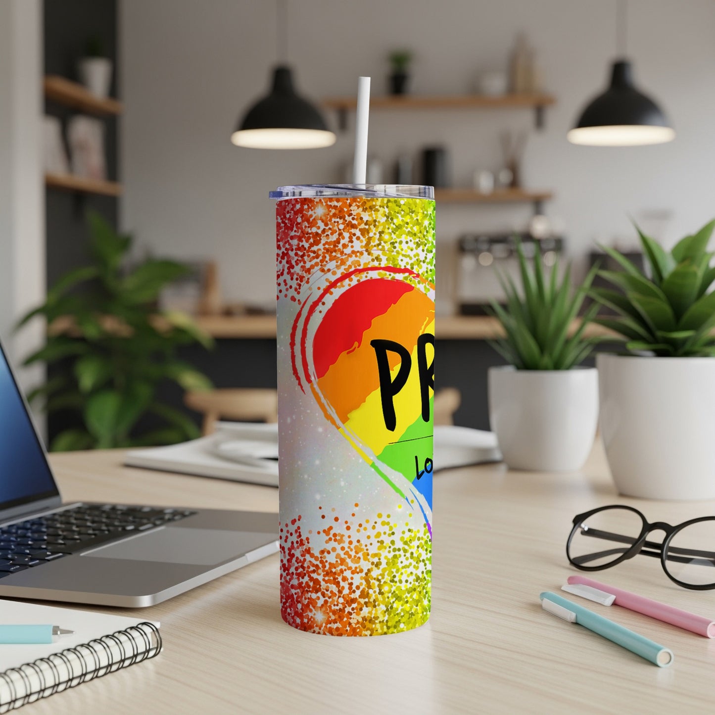Pride rainbow heart tumbler with straw, speckled glitter background.