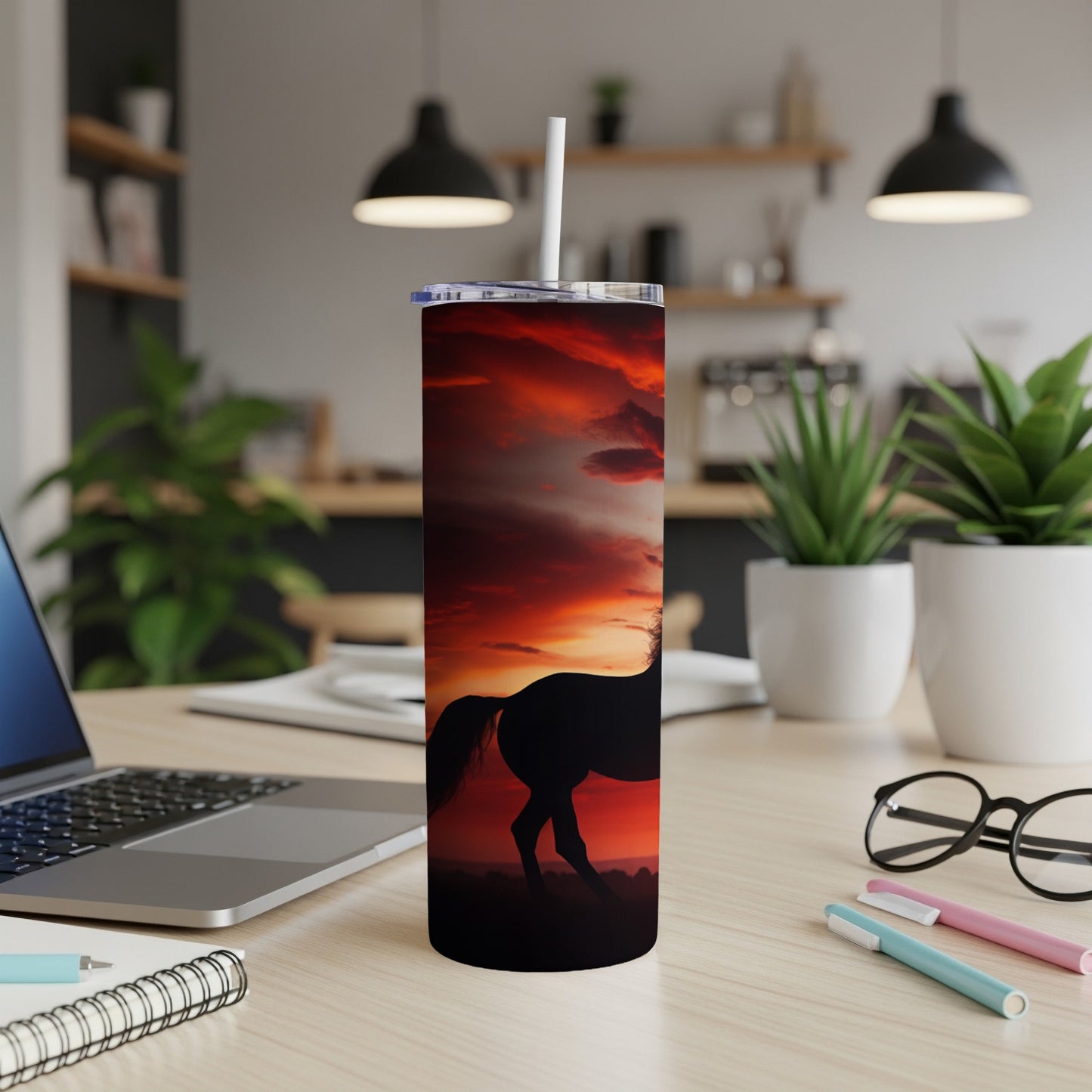 Silhouette of a horse against a vibrant sunset on a tumbler.