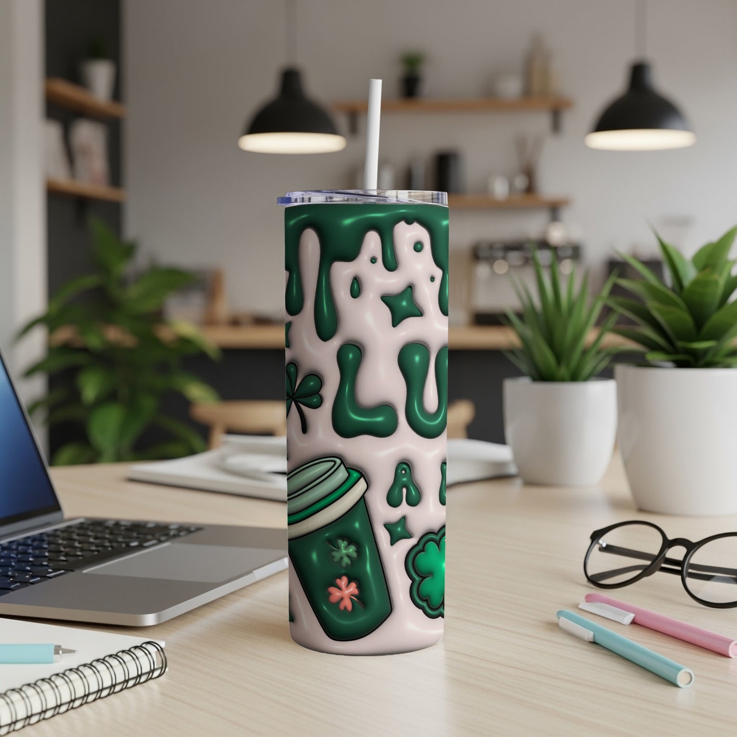 Green shamrock and coffee cup pattern on a tall skinny tumbler with straw.