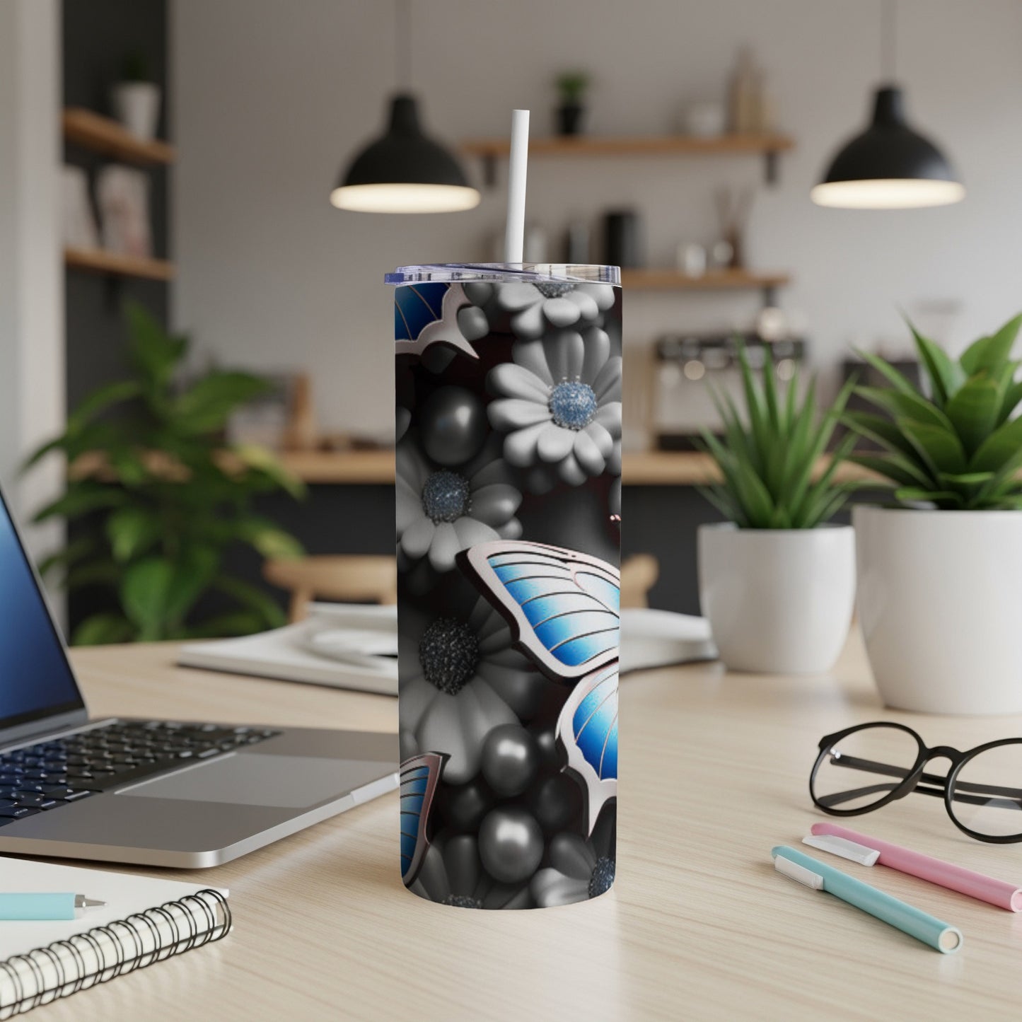 Tall tumbler with blue butterfly and floral pattern.