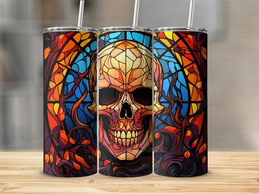 Stained glass skull design on three tumblers with straws.