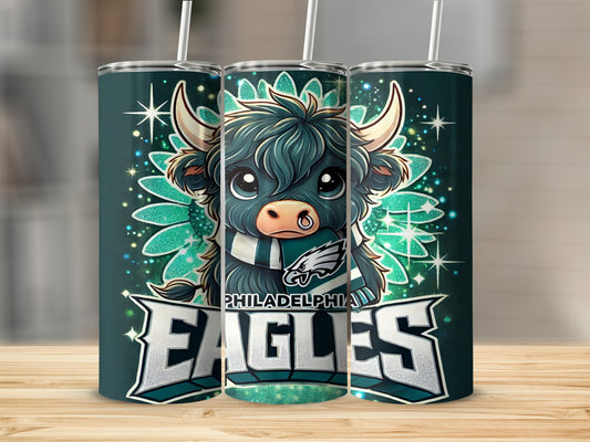 Philadelphia Eagles Highland cow graphic on a dark green tumbler.