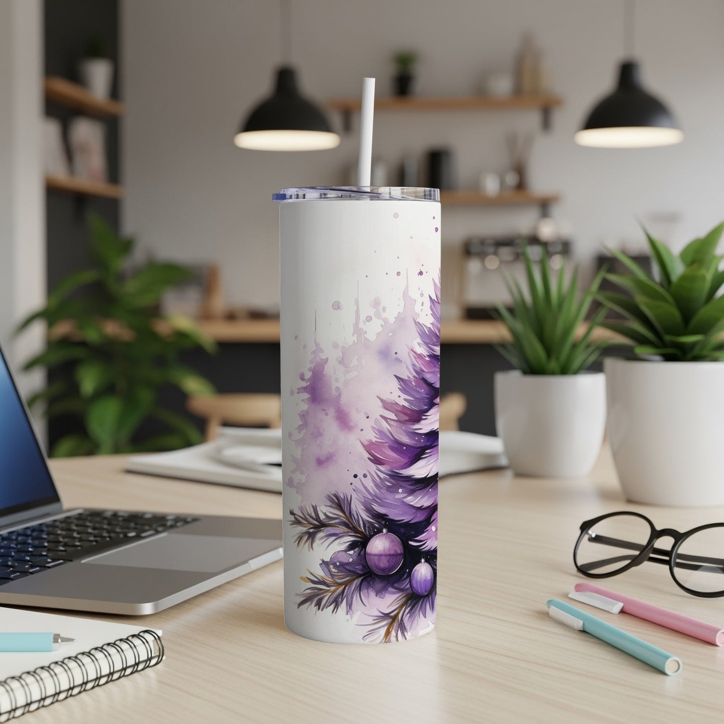 White tumbler with purple watercolor Christmas tree design and ornaments.