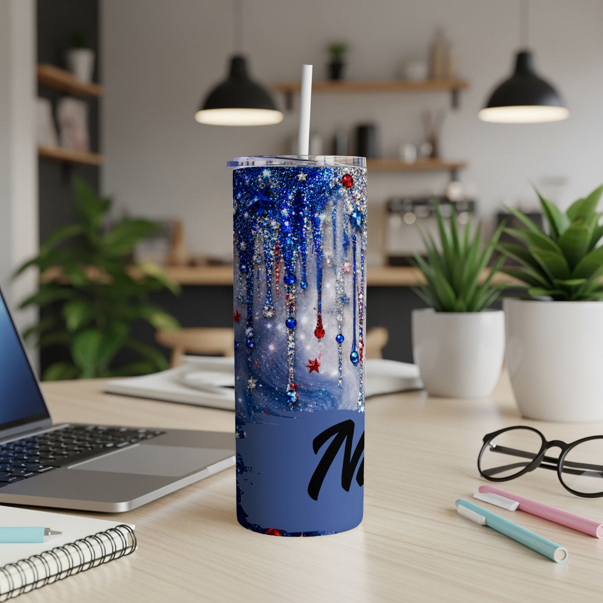 Blue glitter tumbler with patriotic dripping design and a straw.