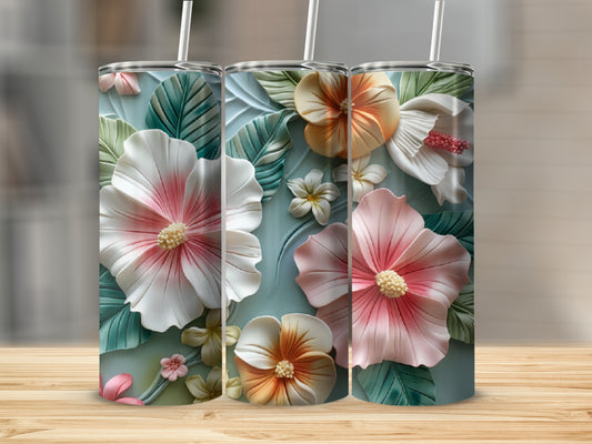 Three tall tumblers featuring embossed tropical flowers and leaves on a light blue background.
