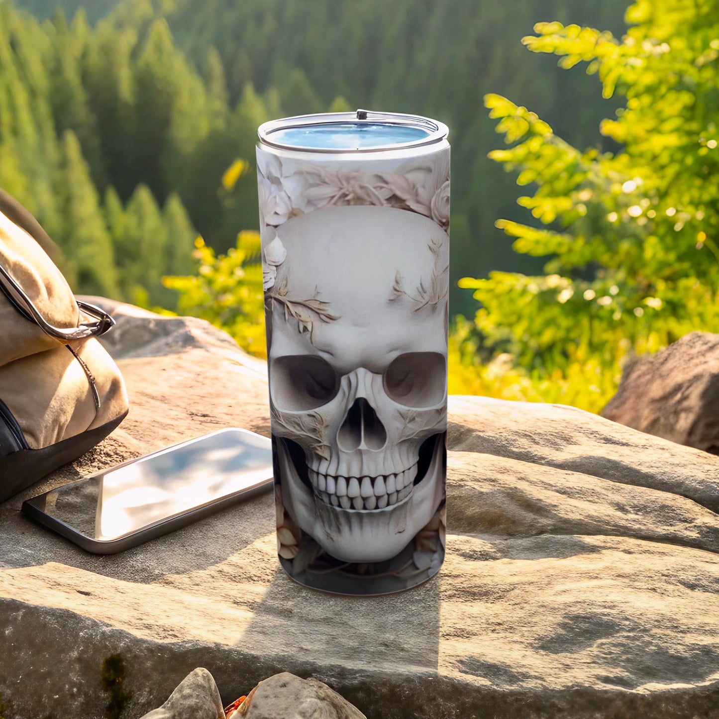 Tumbler with a detailed skull and floral design.