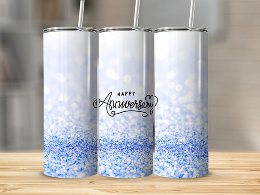 White tumbler with blue glitter and "Happy Anniversary" text.