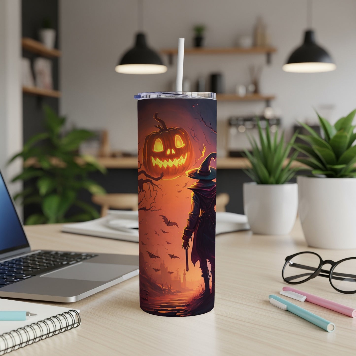 Tumbler with a witch and jack-o'-lantern Halloween design.