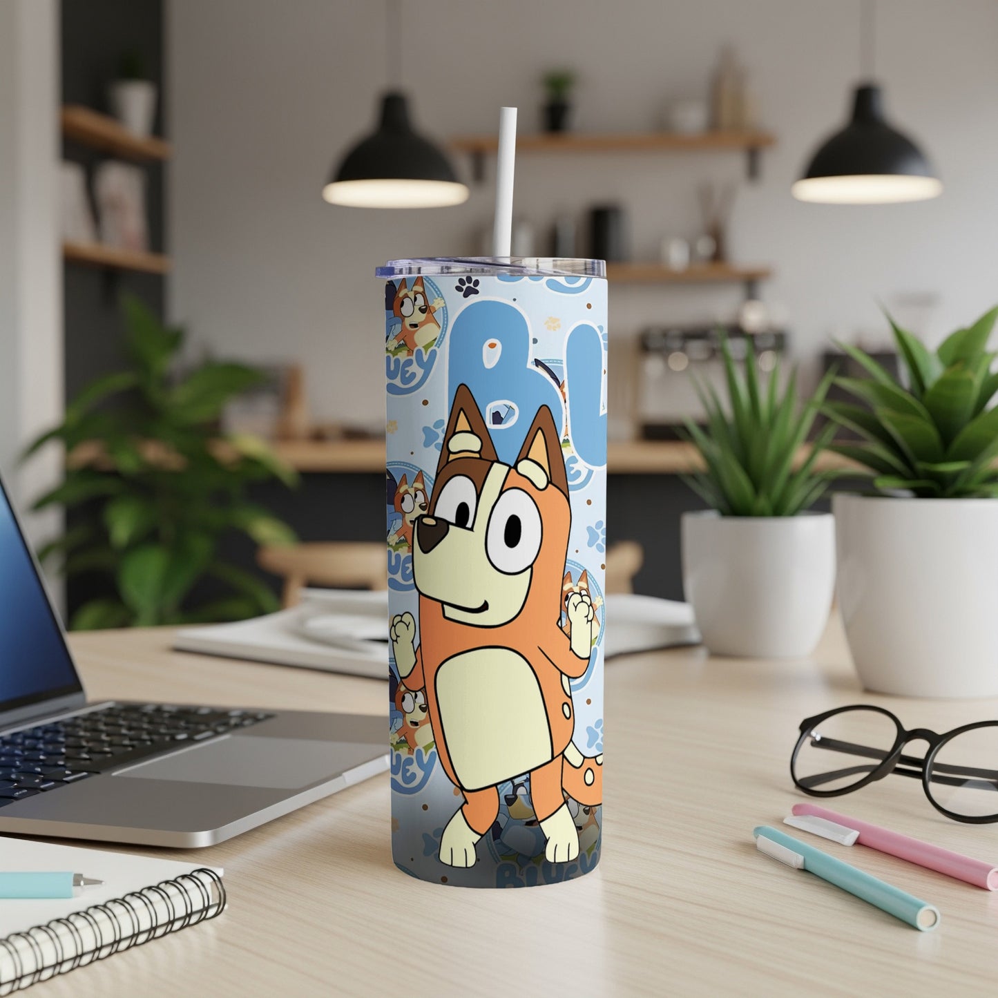 Bluey cartoon dog character on a blue and brown patterned tumbler cup.