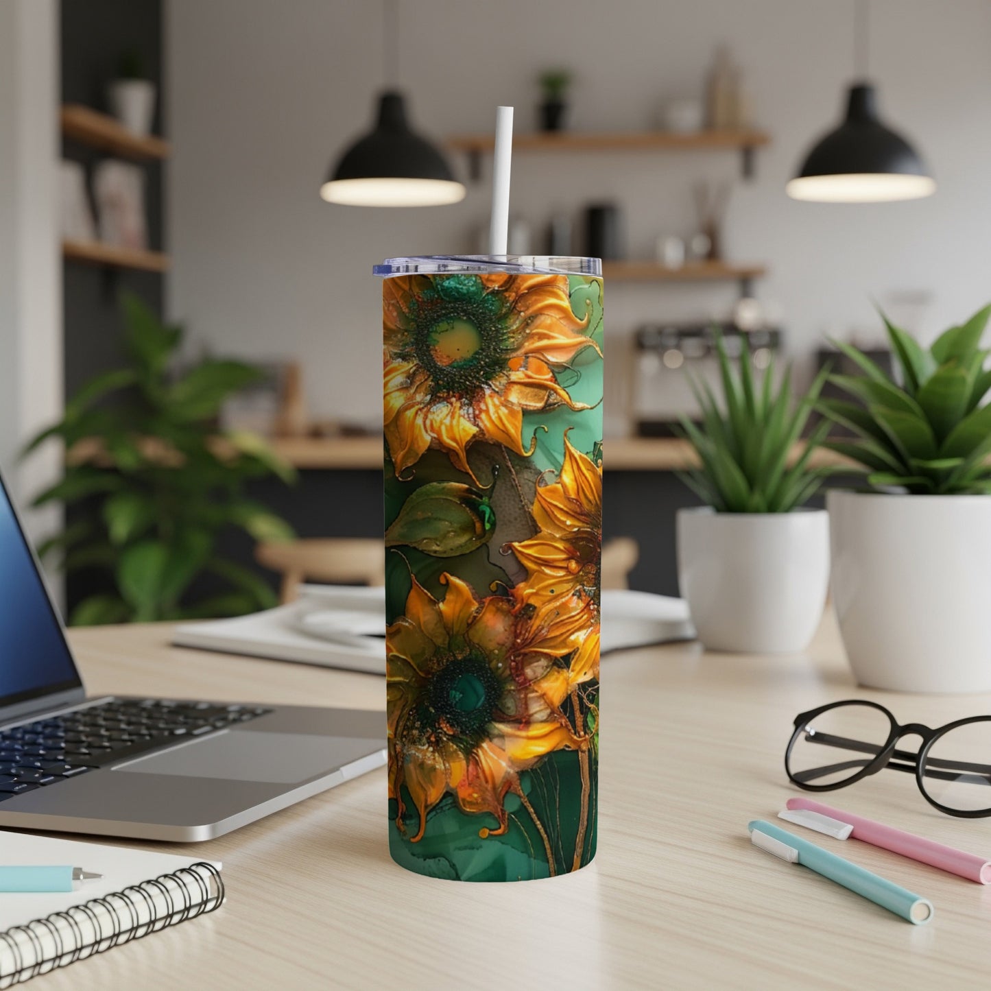 Tall tumbler with vibrant orange sunflowers on a green background.