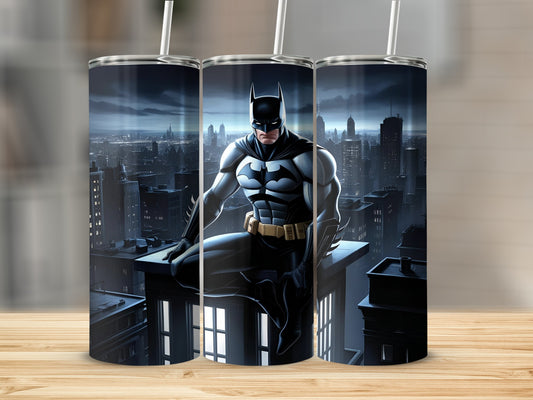 Batman sitting on a building rooftop overlooking a cityscape at night.