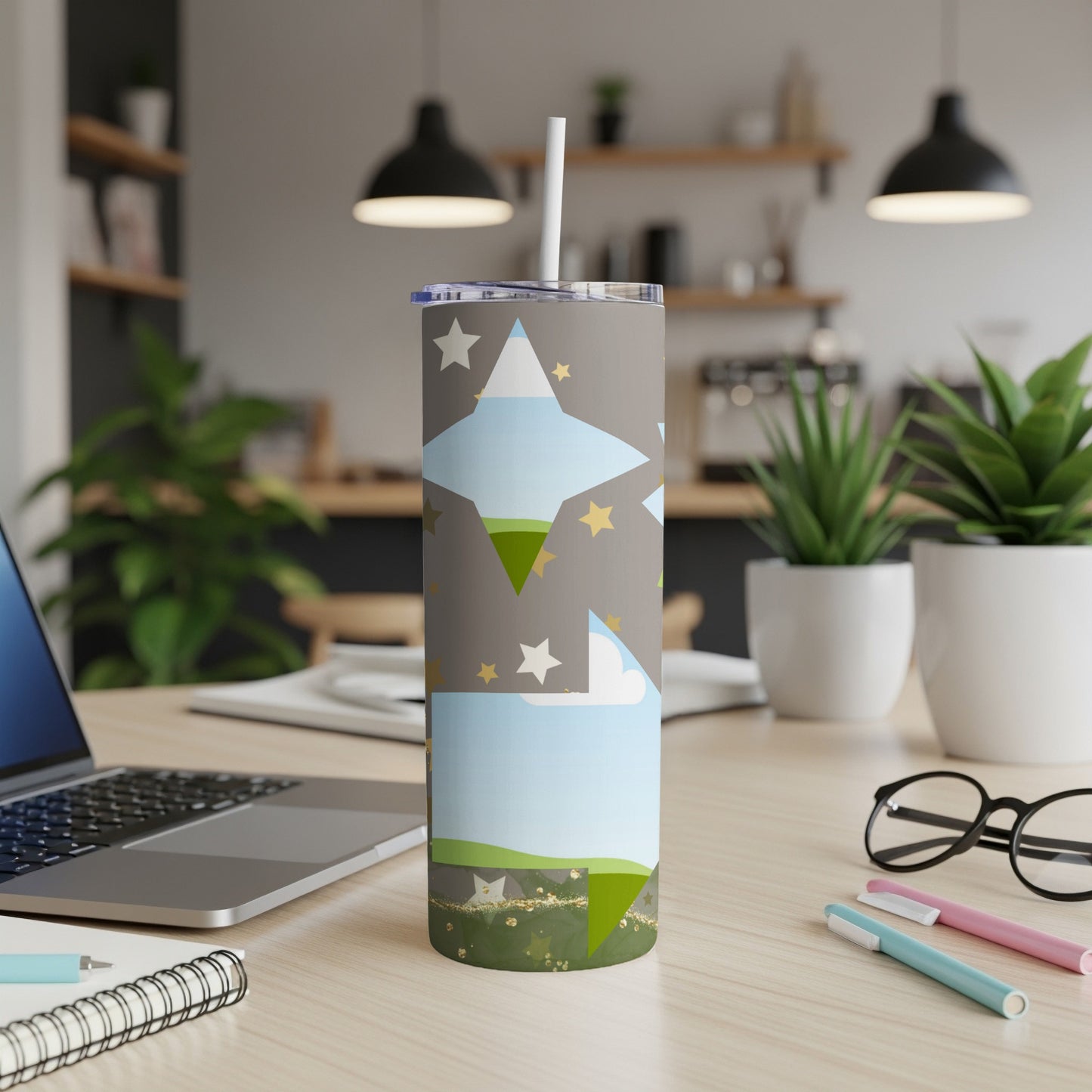 Tumbler with a starry sky and landscape pattern, featuring a straw.