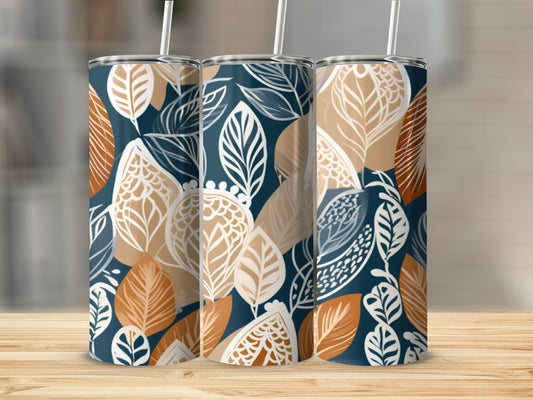 Three tumblers with a blue and white leaf pattern on a wooden surface.