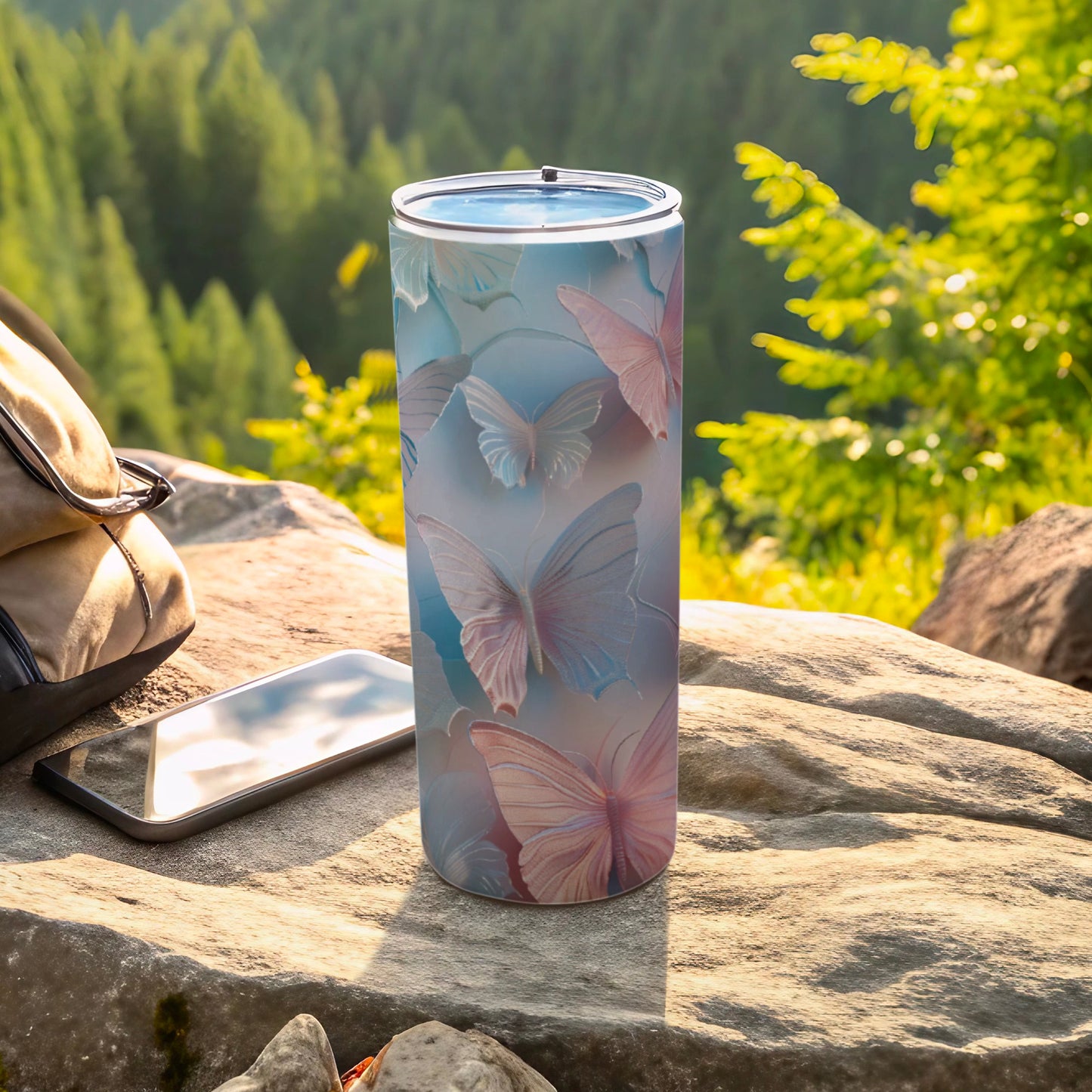 Blue and pink butterflies on a light blue background on a stainless steel tumbler.