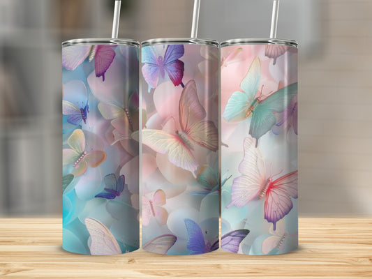 Three tumblers with colorful butterfly designs, displayed on a wooden surface.