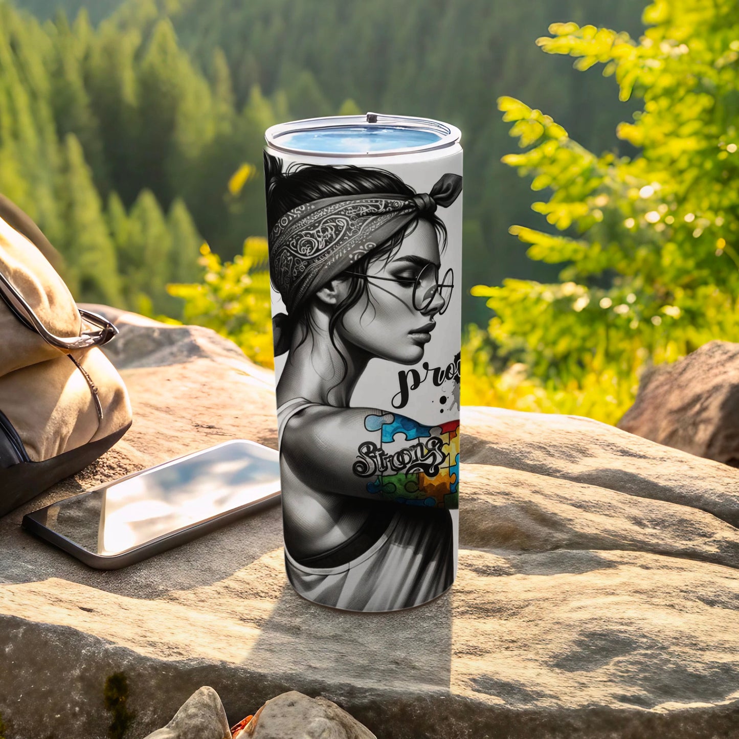 Black and white tumbler with woman's portrait, puzzle piece tattoo, and "Strong" text.