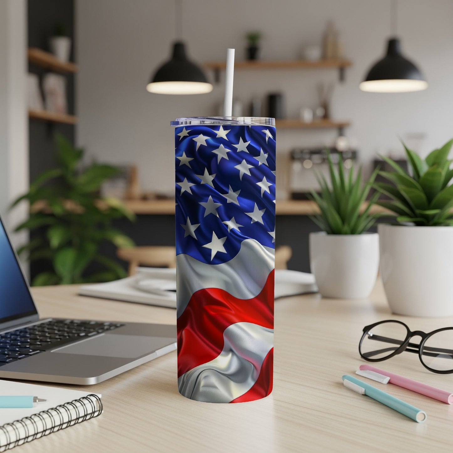American flag tumbler with white straw on a desk.