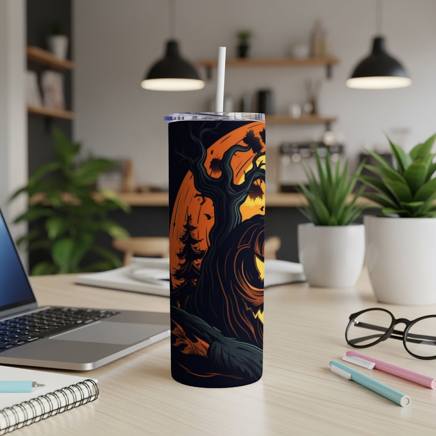 Tumbler with Halloween tree and jack-o'-lantern design, with straw and lid.