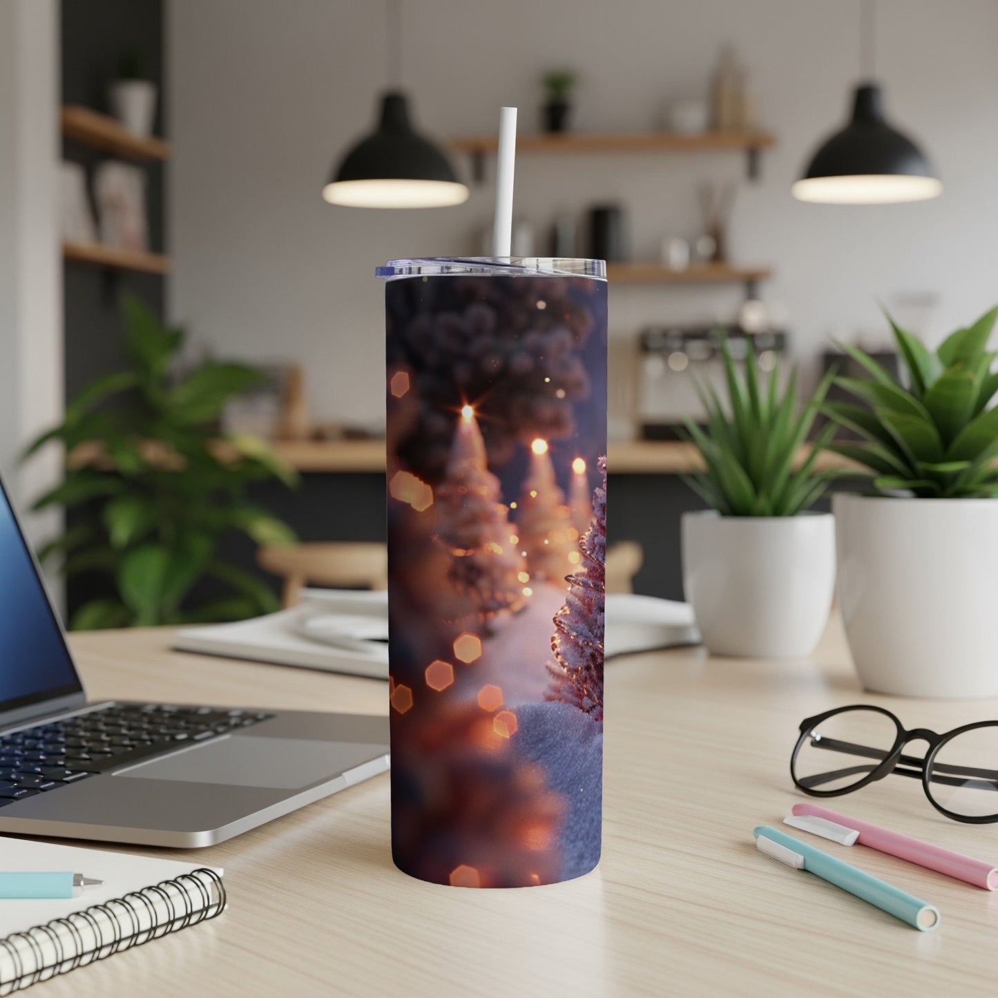 Christmas tree tumbler with bokeh lights on desk.