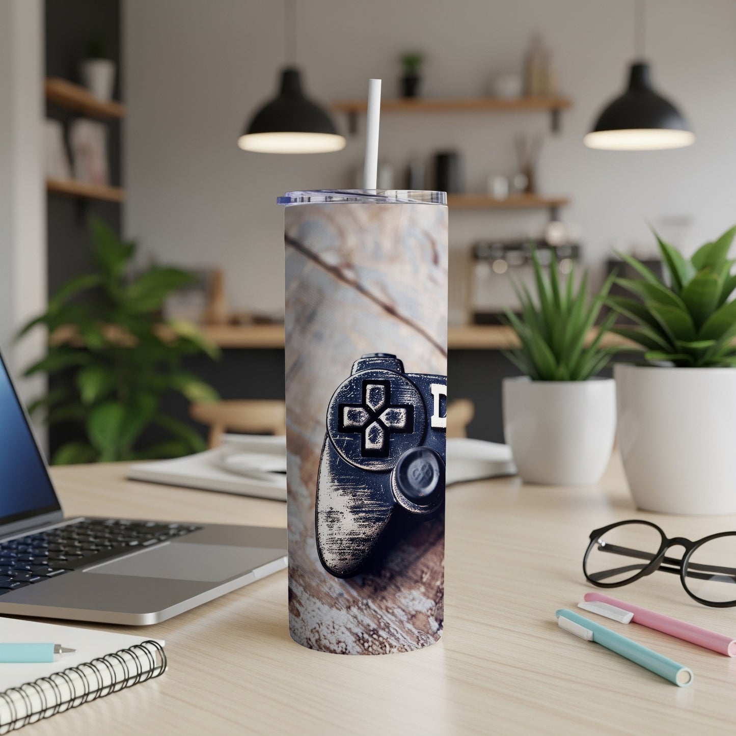 Video game controller on wood grain tumbler with office desk in background.