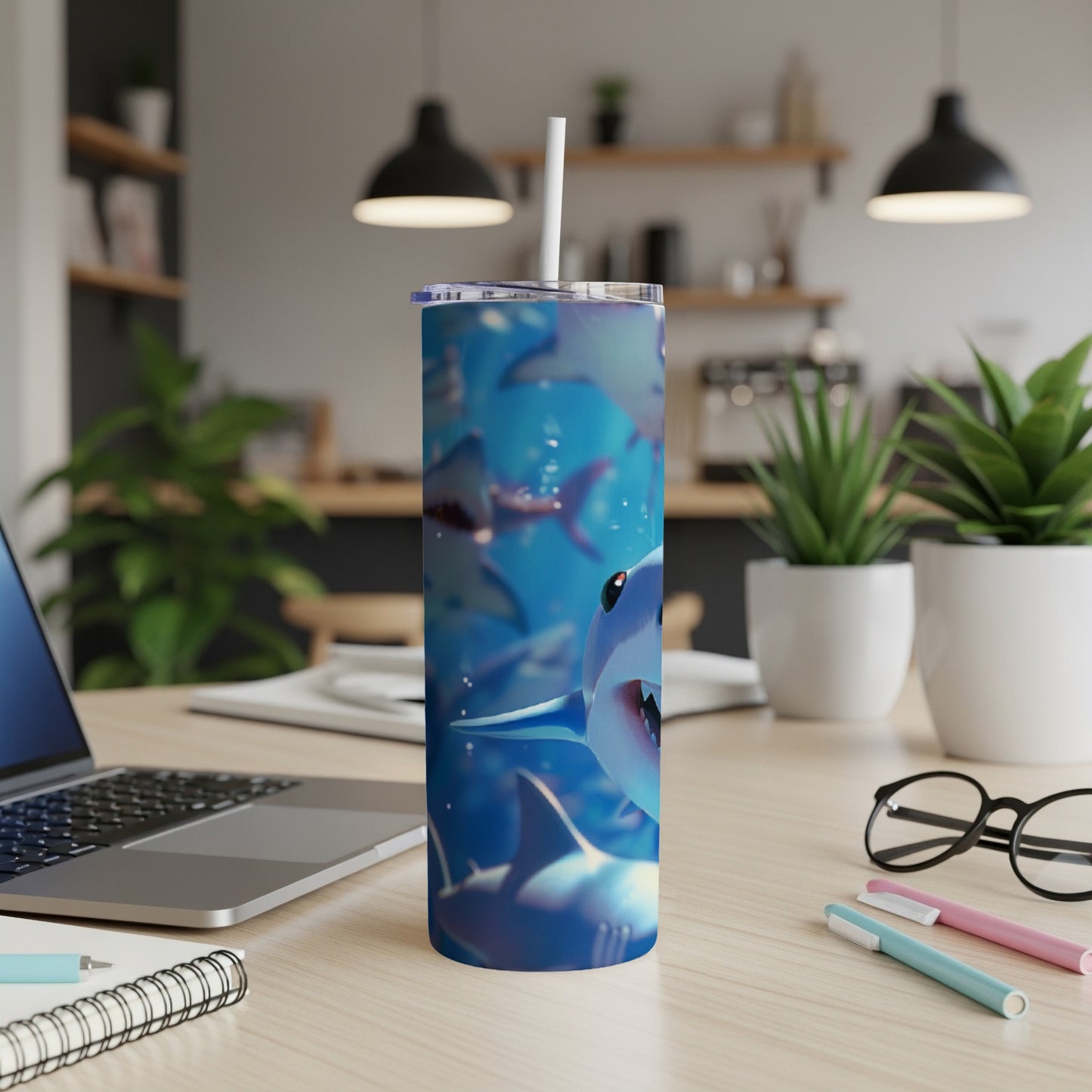 Tumbler with cartoon sharks underwater graphic.
