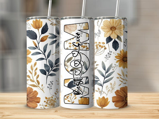 White tumbler with "Best Mom" text and floral pattern.