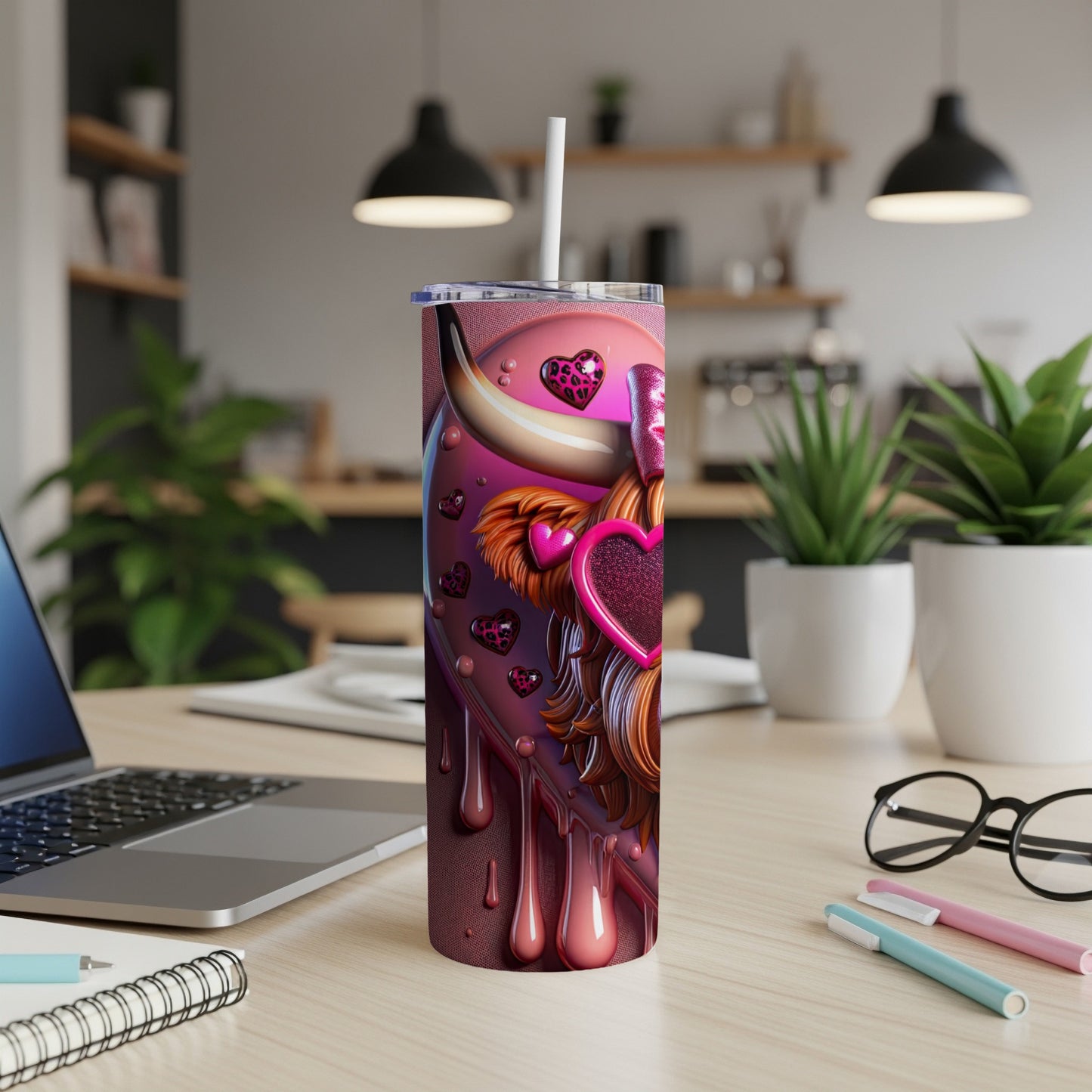 Pink cow print tumbler with heart designs and a straw.