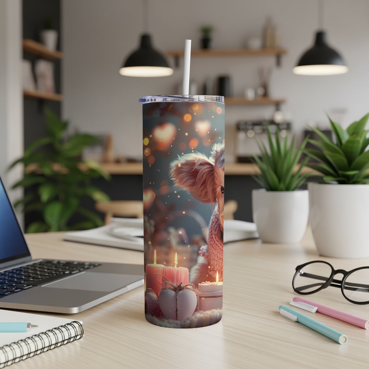 Squirrel and candles on a desktop tumbler with a straw.
