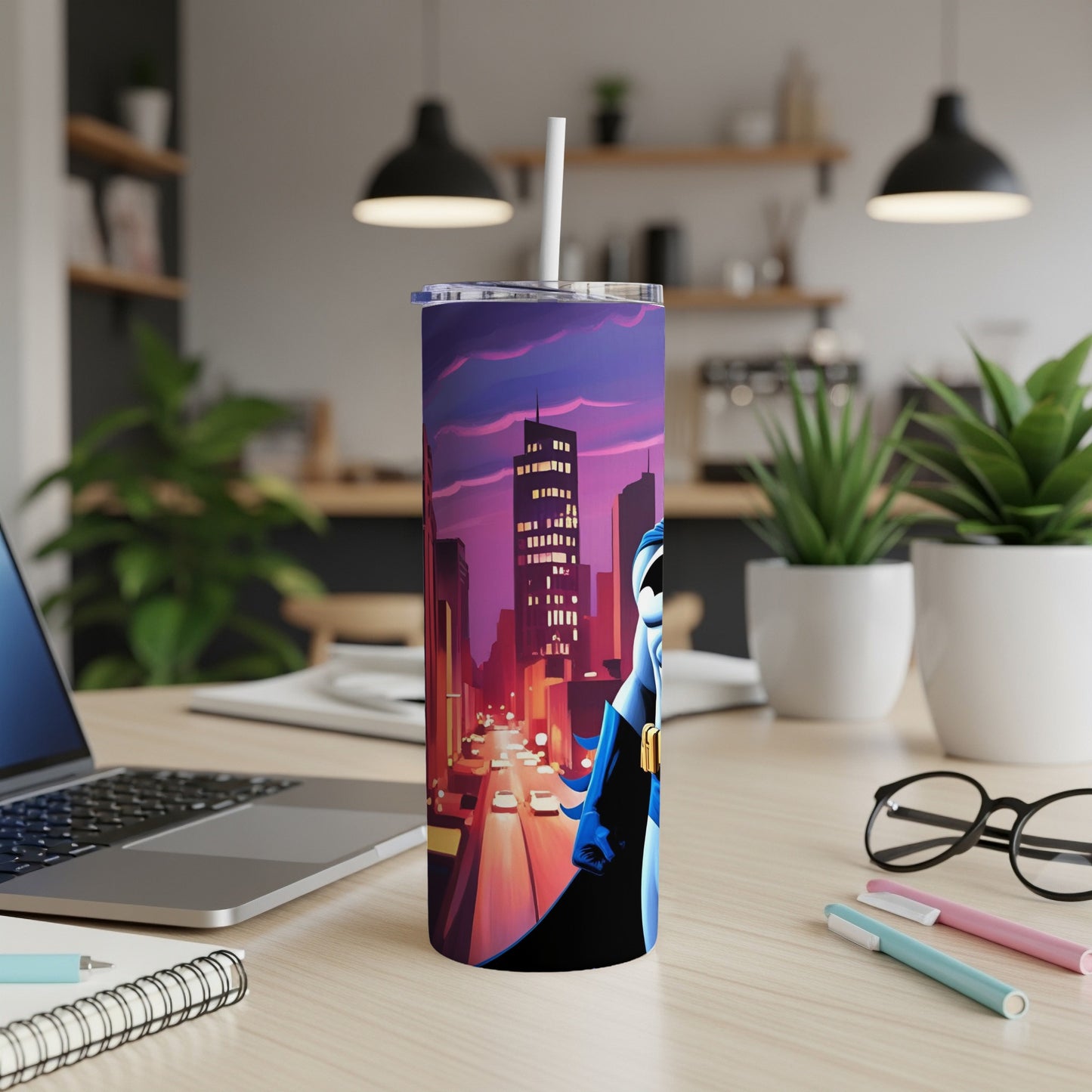 Superhero tumbler with cityscape background on a desk.