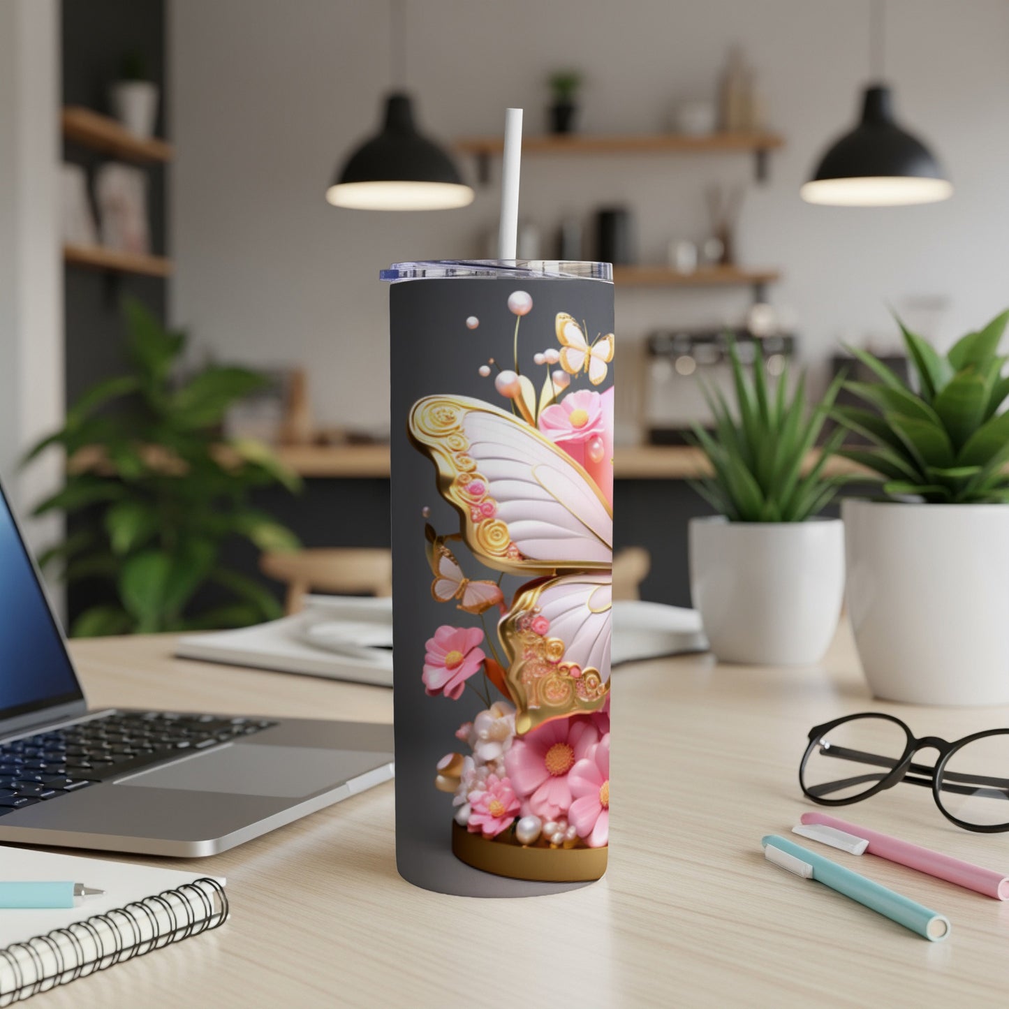 Tall tumbler with a pink and gold butterfly design.