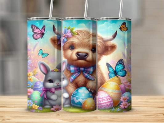 Highland cow, bunny, Easter eggs, and butterflies on a tumbler.