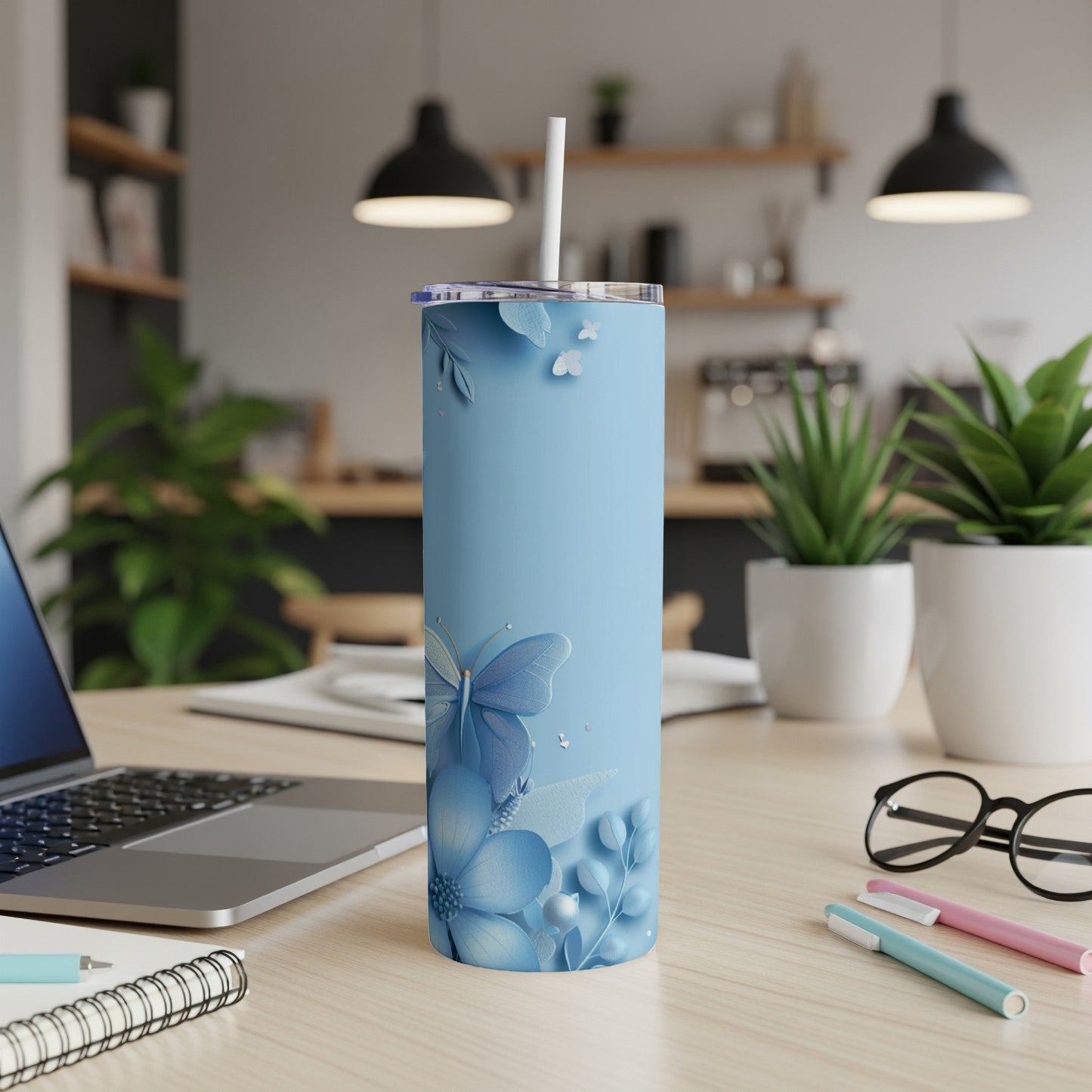 Light blue floral tumbler with butterfly design and straw.
