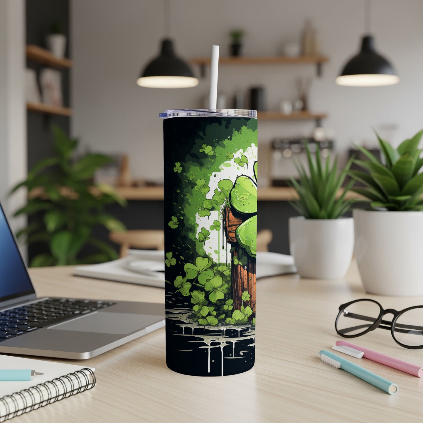 Green shamrocks and a dark background on a stainless steel tumbler.