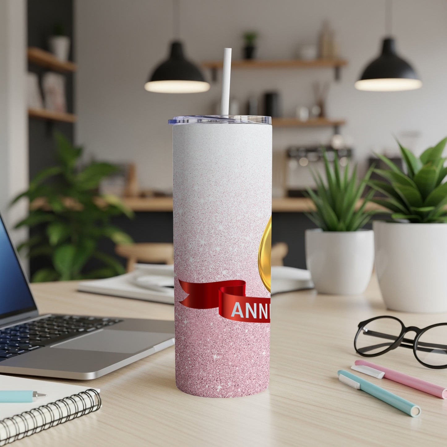 White tumbler with pink glitter and a red ribbon displaying "ANNIVERSARY".