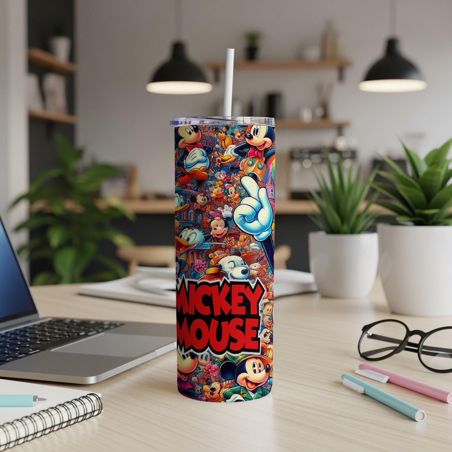 Mickey Mouse collage pattern on a white insulated tumbler with straw.