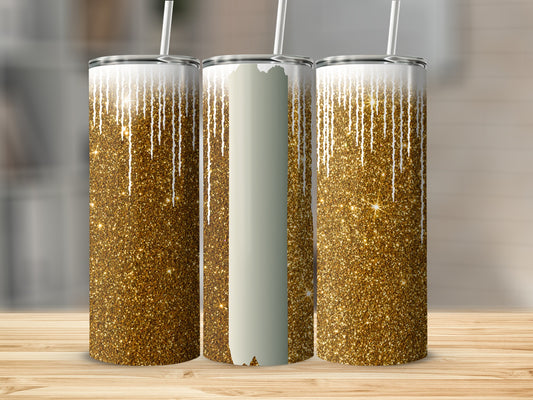 Three glittery gold tumblers with dripping white accents on a wooden surface.