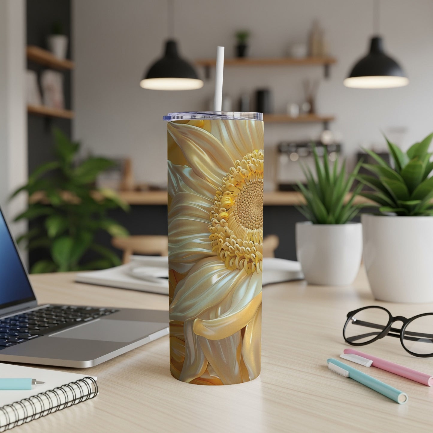 Yellow and white sunflower pattern on a stainless steel tumbler with a straw.