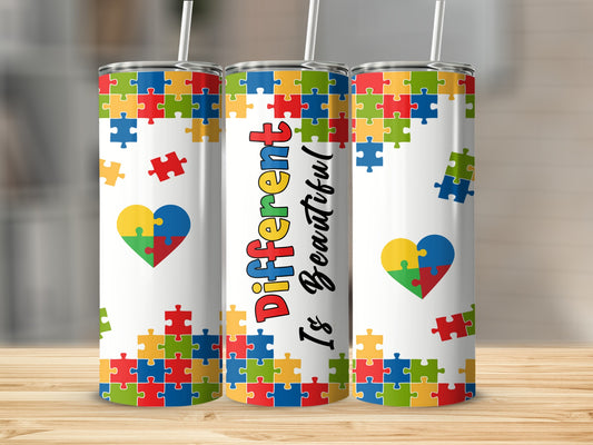 Three white tumblers with colorful puzzle pieces and "Different Is Beautiful" text.
