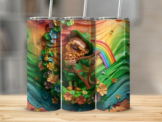 Leprechaun playing a harp with flowers and a rainbow on a tumbler.